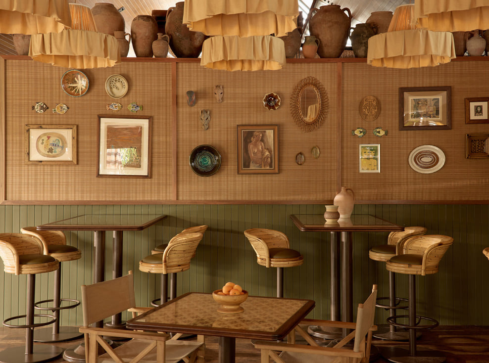 Warmly styled interior with rattan bar stools and curated decor